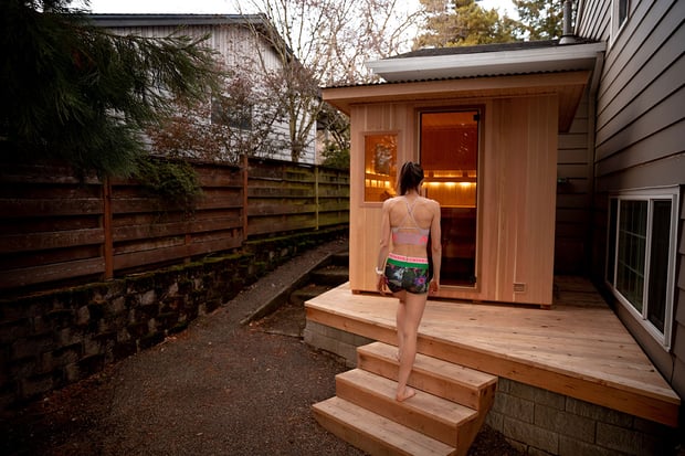 a woman walking towards sauna room