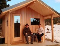 two person sitting outside a house